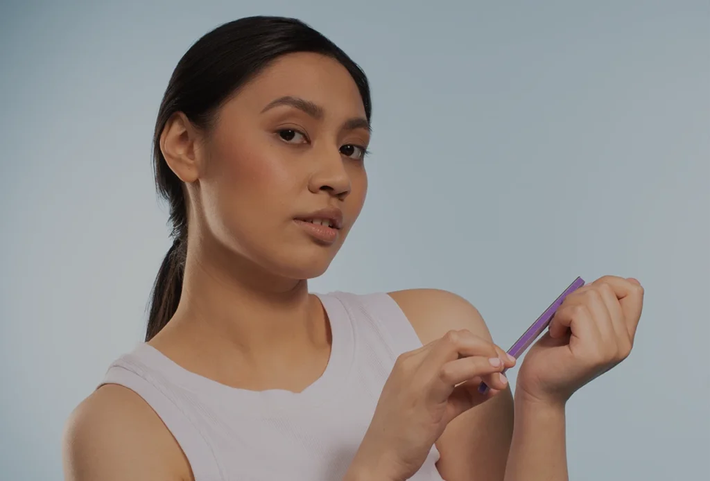 Girl doing manicure for herself with Urzo Interchangeable nail files